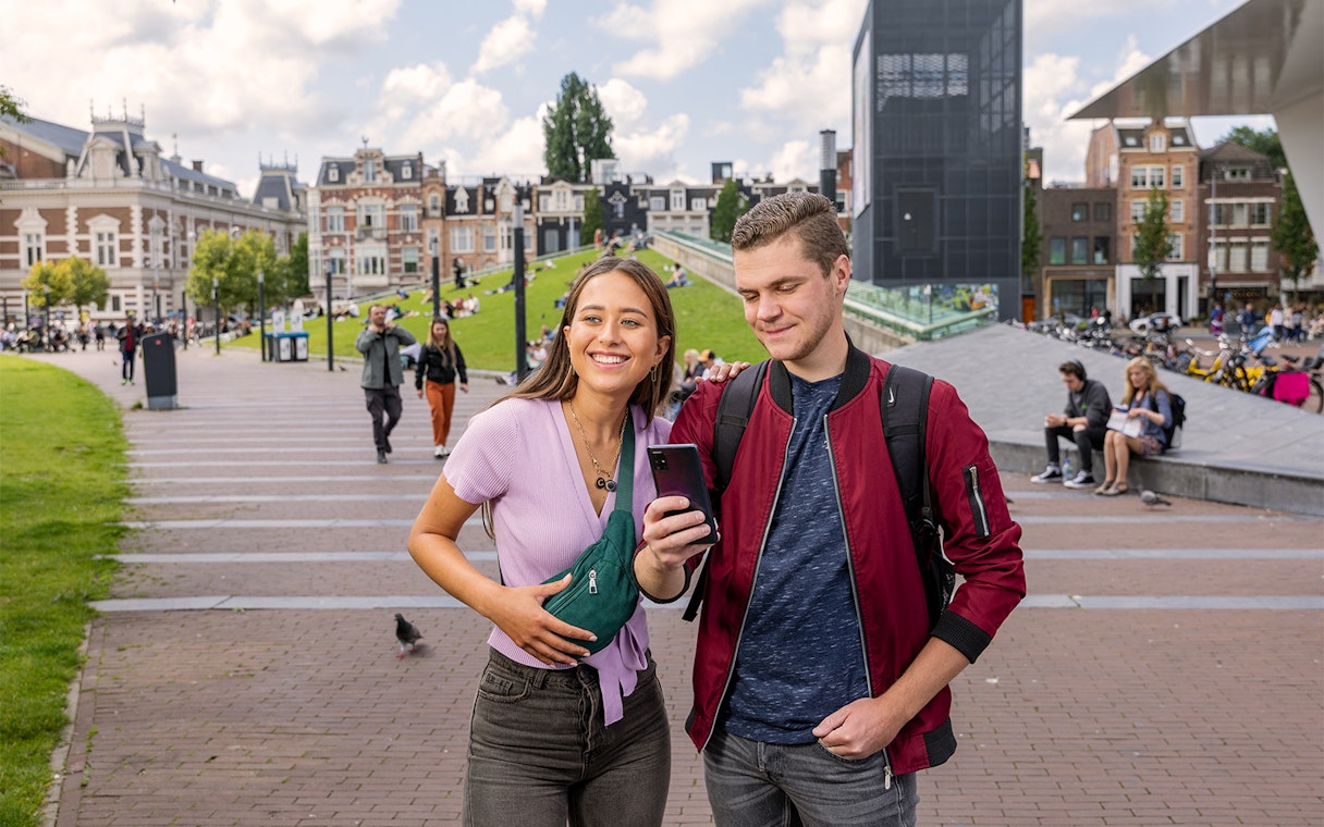 Tourists using I amsterdam City Card near Museumplein, Amsterdam.