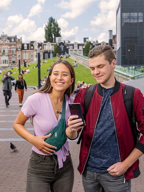 Tourists using I amsterdam City Card near Museumplein, Amsterdam.
