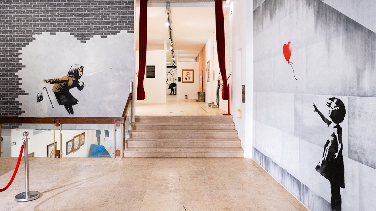 Banksy murals at The World of Banksy exhibit in Lisbon.