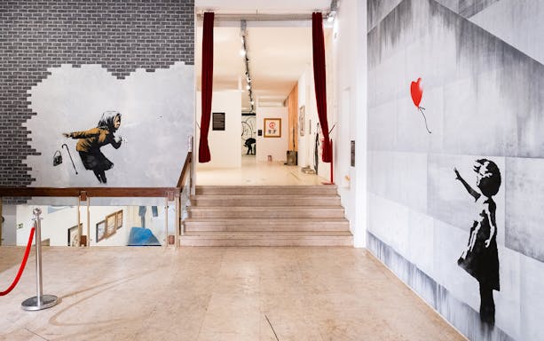 Banksy murals at The World of Banksy exhibit in Lisbon.