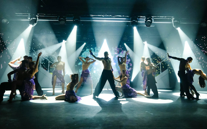 Dancers performing on stage with dramatic lighting at Sala Scala, Gran Canaria.