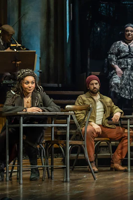 Cast performing on stage in Hadestown musical.