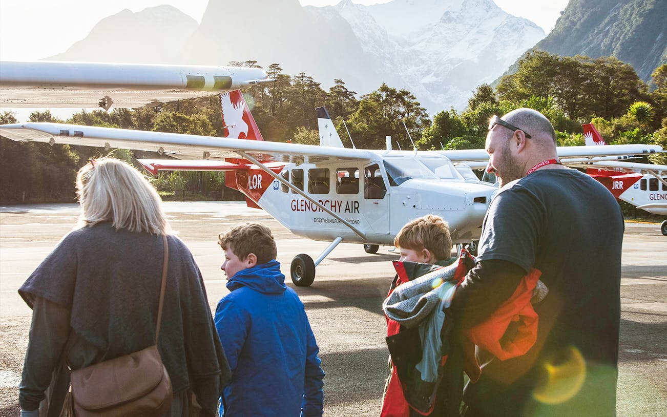 Family boarding plane for Milford Sound tour, New Zealand.