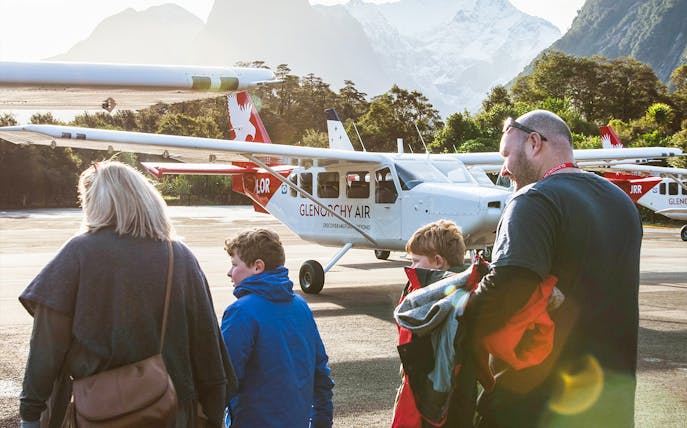 Family boarding plane for Milford Sound tour, New Zealand.