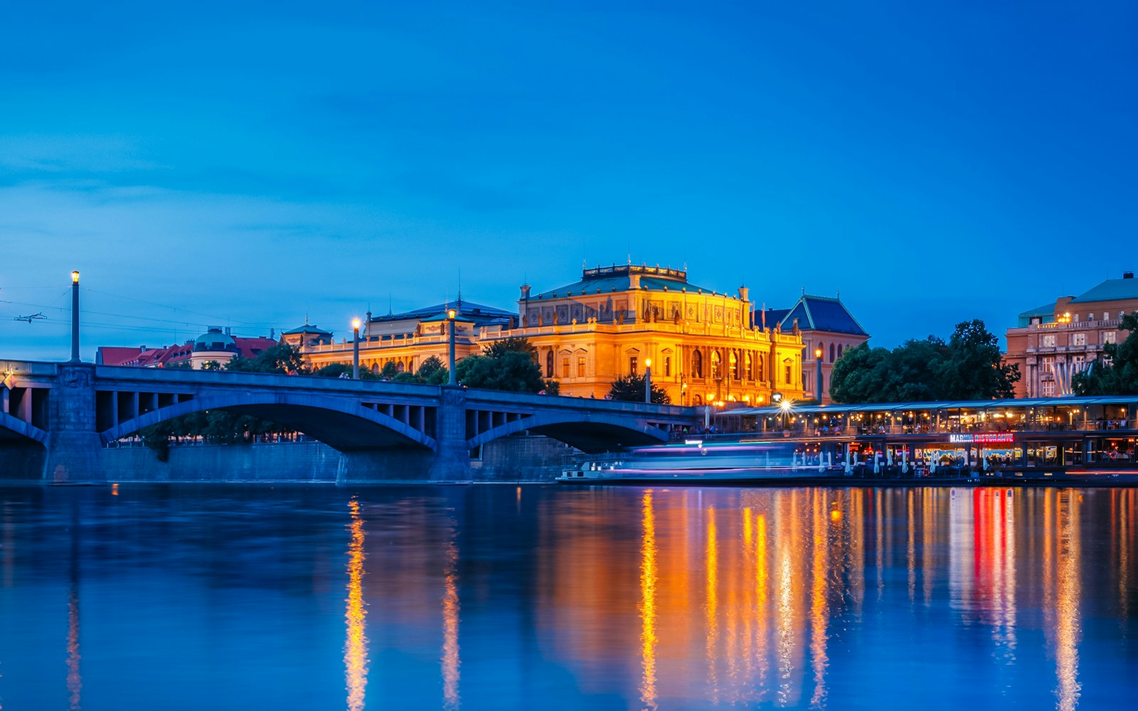 Rudolfinum illuminated at night by the Vltava River, Prague, Czech Republic.