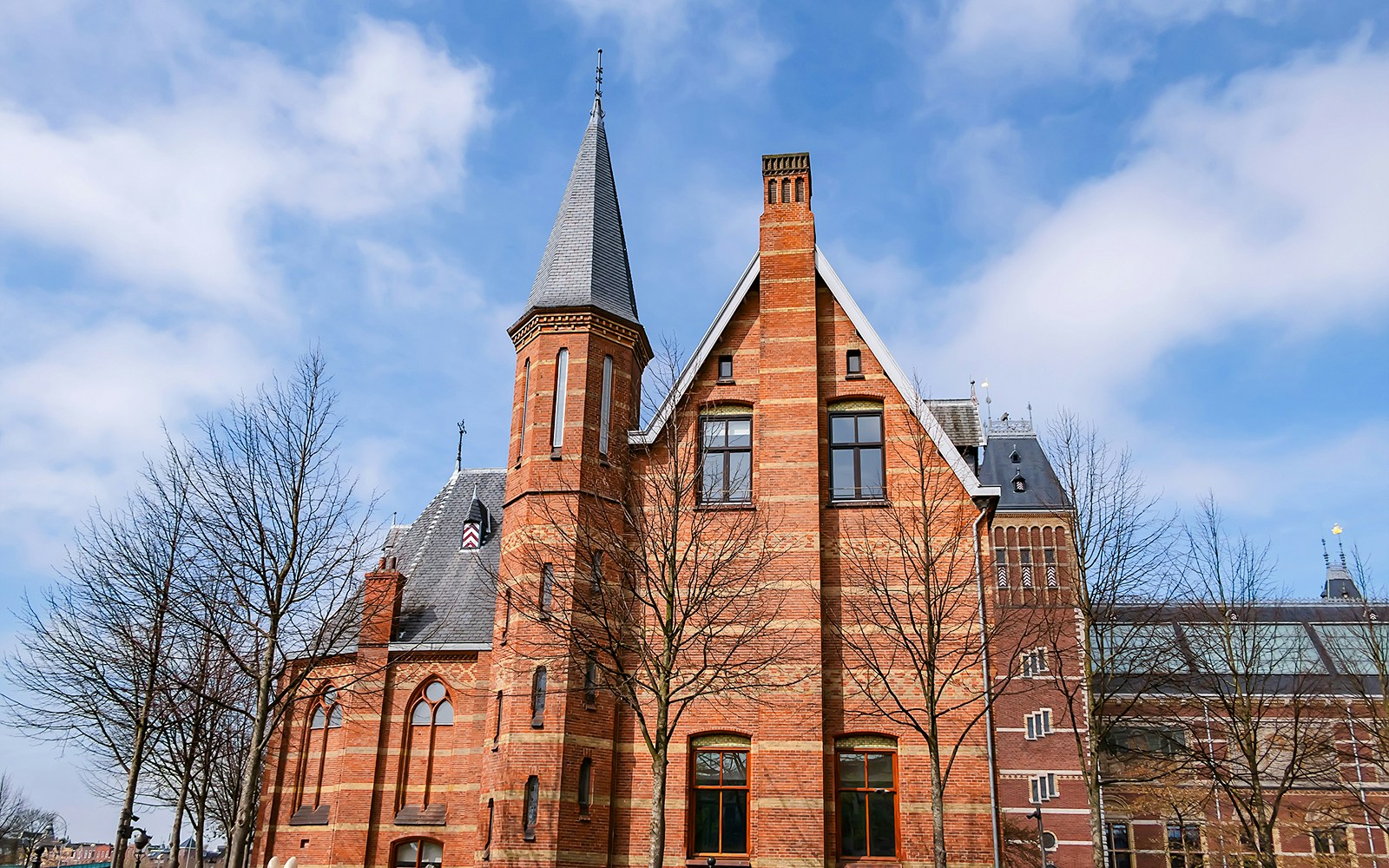 Rijksmuseum Teekenschool building with red brick facade and pointed tower in Amsterdam.