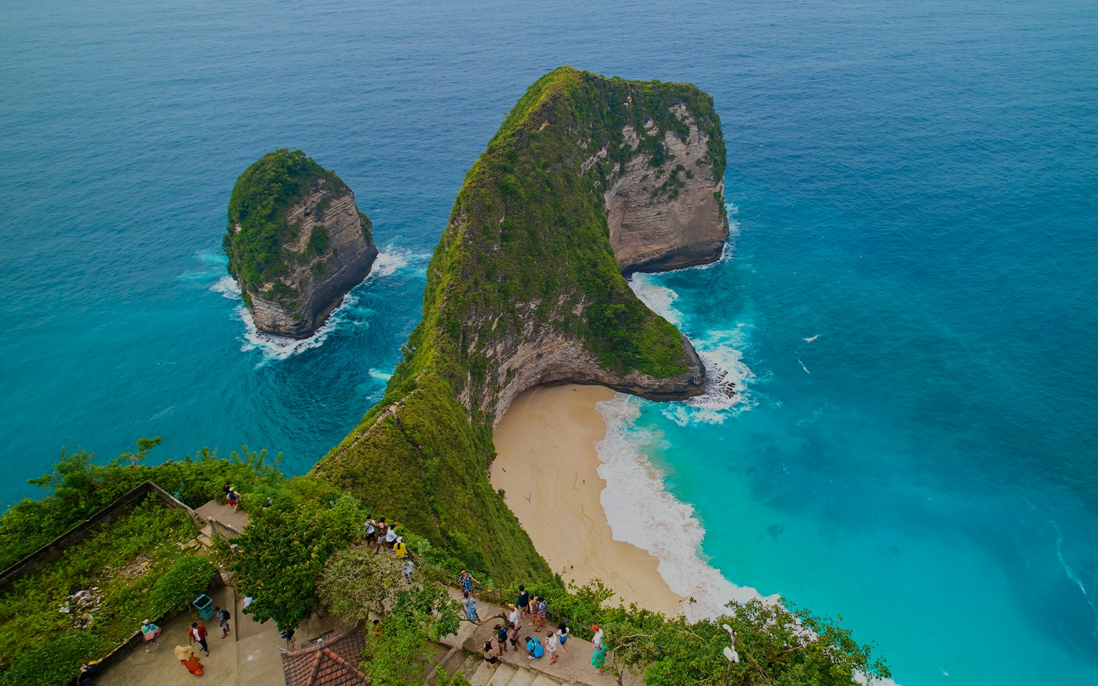 Group of tourists exploring the scenic beauty of West Nusa Penida Island, Indonesia, with convenient hotel transfers included in the tour package
