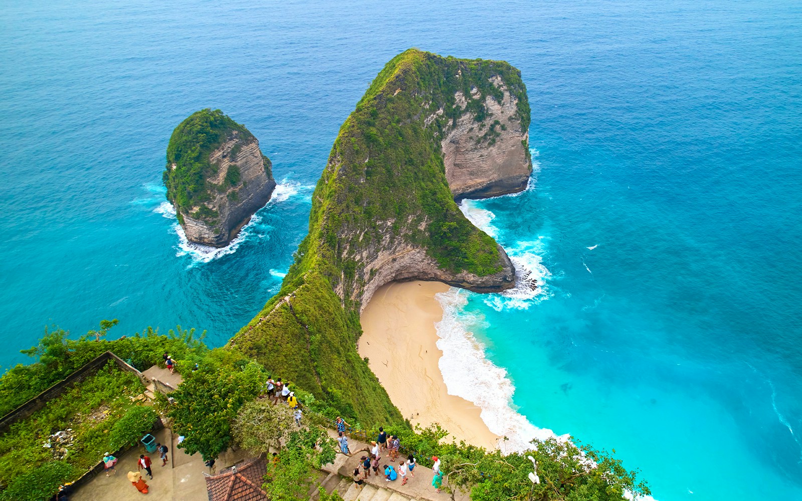 Group of tourists exploring the scenic beauty of West Nusa Penida Island, Indonesia, with convenient hotel transfers included in the tour package