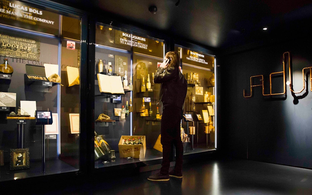 Visitor exploring exhibits at Bols Cocktail Experience in Amsterdam.