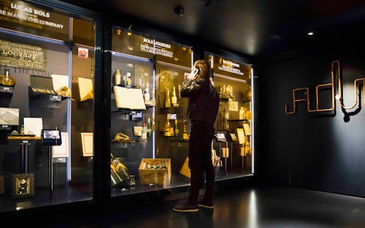 Visitor exploring exhibits at Bols Cocktail Experience in Amsterdam.
