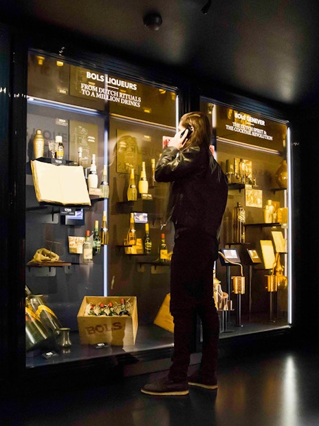 Visitor exploring exhibits at Bols Cocktail Experience in Amsterdam.