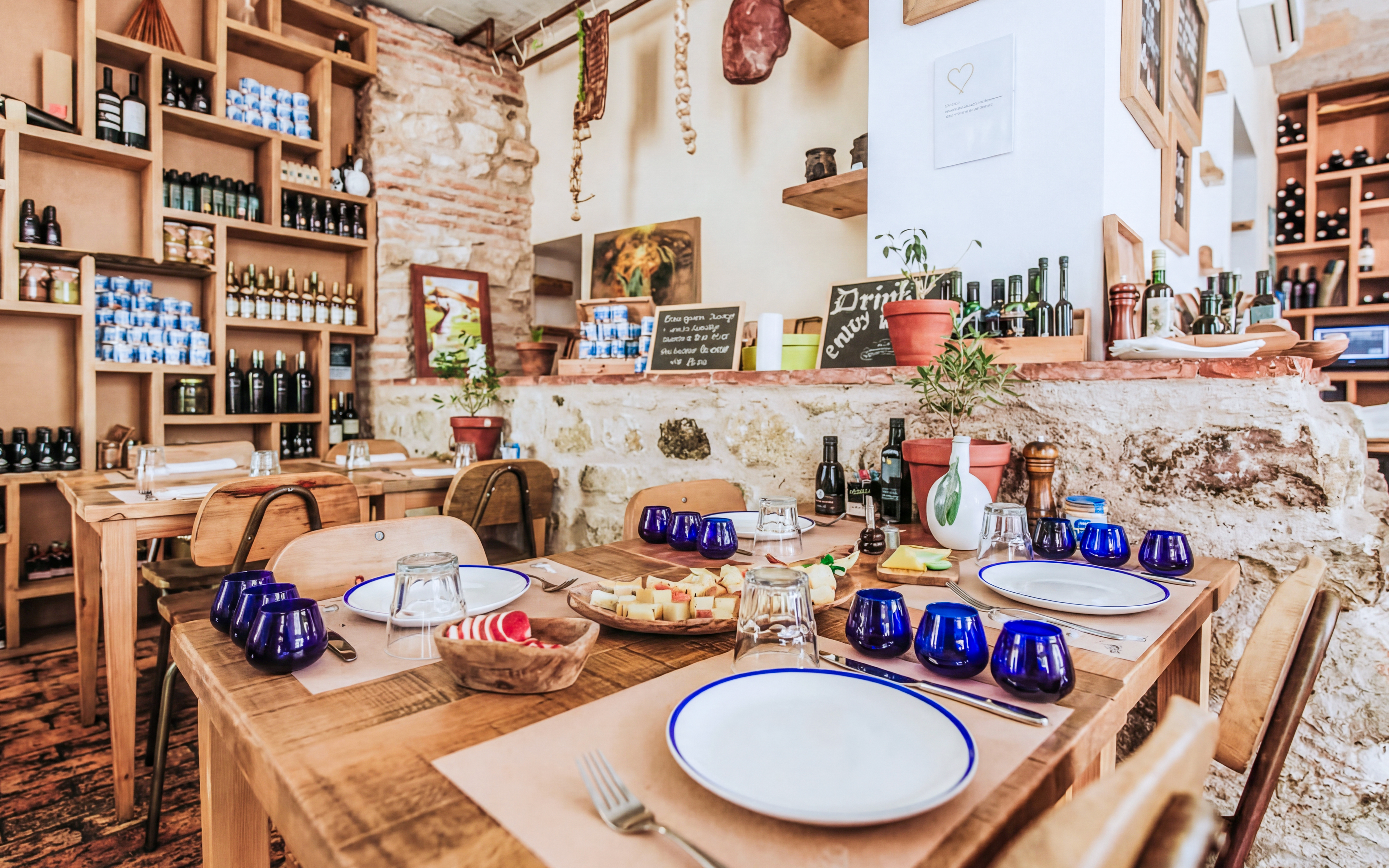 Wine tasting setup in Diocletian’s Palace with cheese platter and blue glasses.
