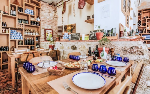 Wine tasting setup in Diocletian’s Palace with cheese platter and blue glasses.