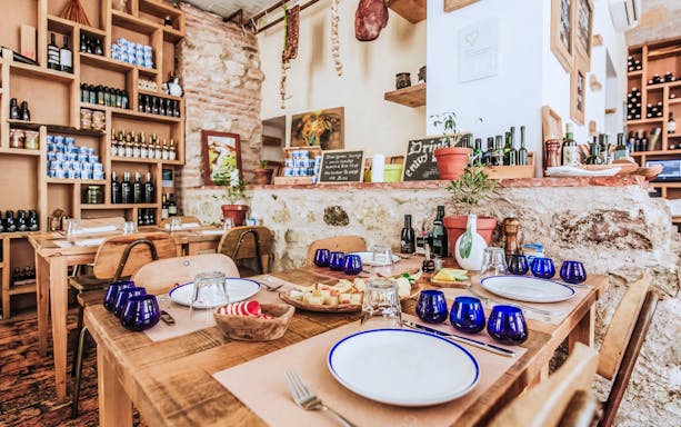 Wine tasting setup in Diocletian’s Palace with cheese platter and blue glasses.