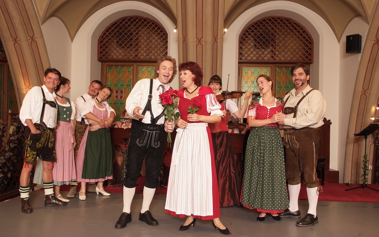 Performers in traditional attire at a Waltz- & Operetta Dinner Show, Vienna city hall.