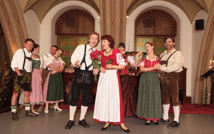 Performers in traditional attire at a Waltz- & Operetta Dinner Show, Vienna city hall.