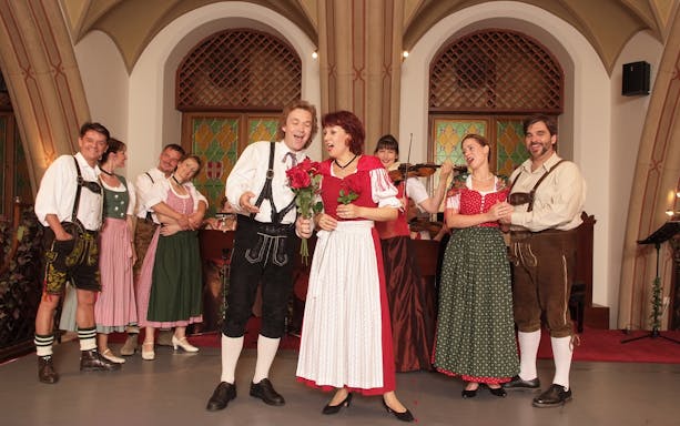 Performers in traditional attire at a Waltz- & Operetta Dinner Show, Vienna city hall.