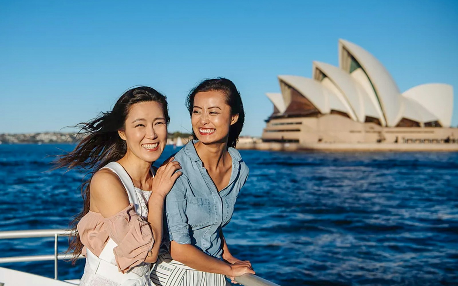 Women observing whales from a boat on a Sydney whale watching cruise.