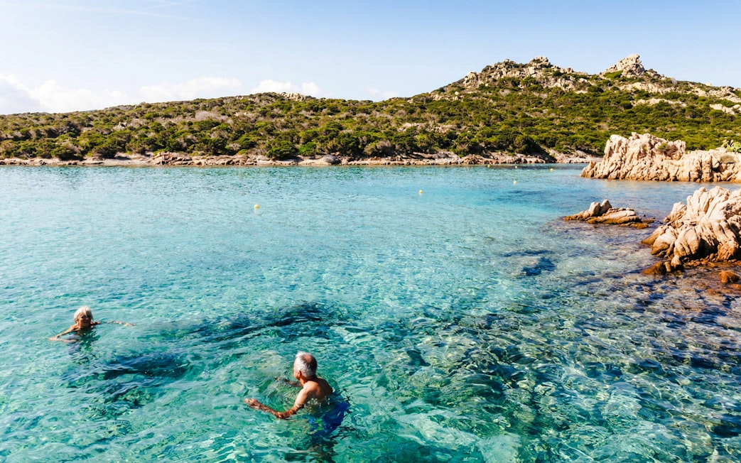 Swimmers in clear waters of La Maddalena Archipelago during 4-hour RIB tour.