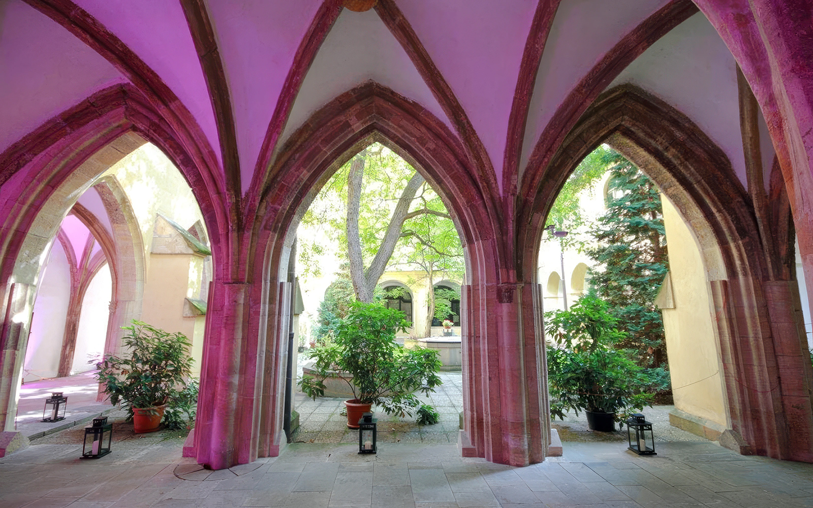 Corridor with arches and plants at Minorite Friary of St. James, Prague.