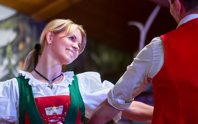 Dancers in traditional Tyrolean attire performing at the Gundolf Family Folk Show.
