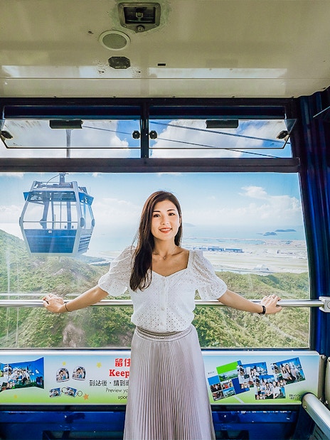 Standard cable car interior at Ngong Ping 360, Hong Kong with scenic mountain and sea views.