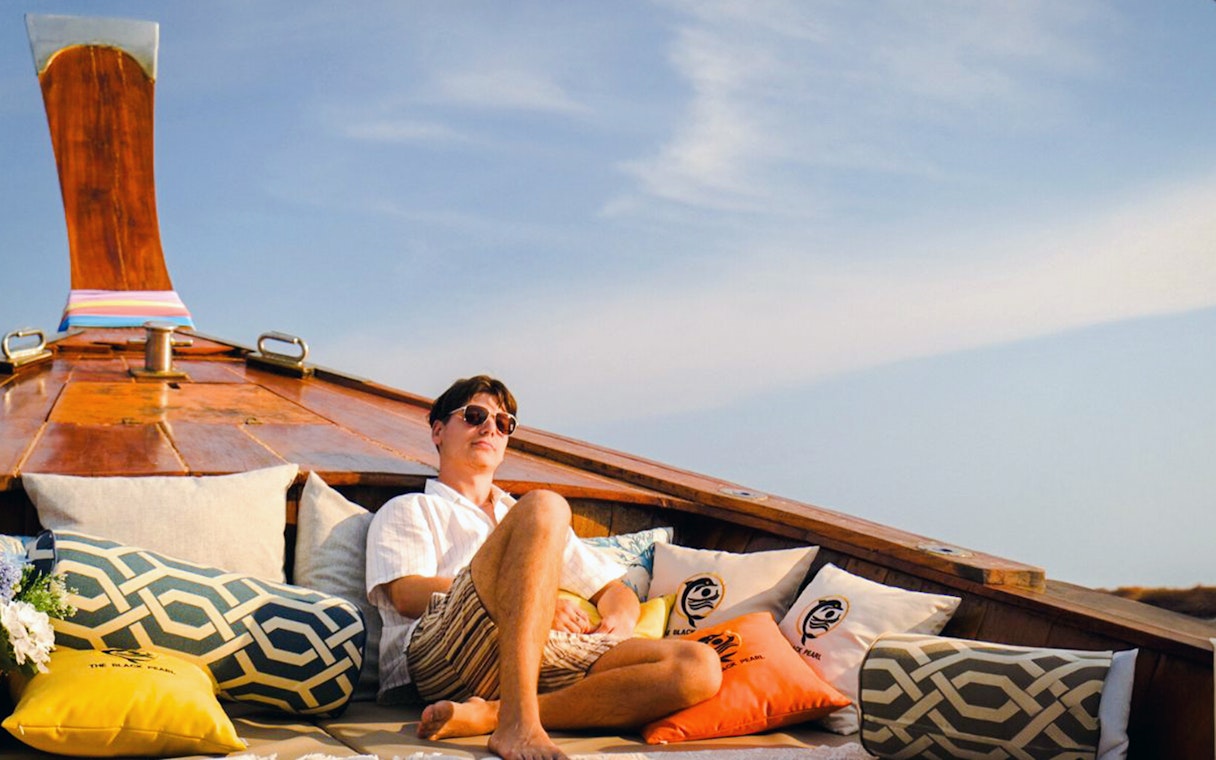 Tourist relaxing on a luxury longtail boat during Krabi: Koh Hong Half Day Tour.