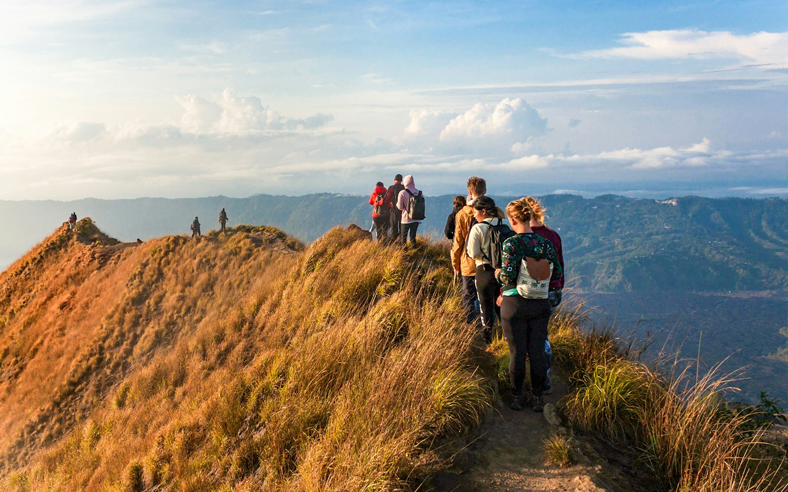Group of people trekking Mount Batur during sunrise