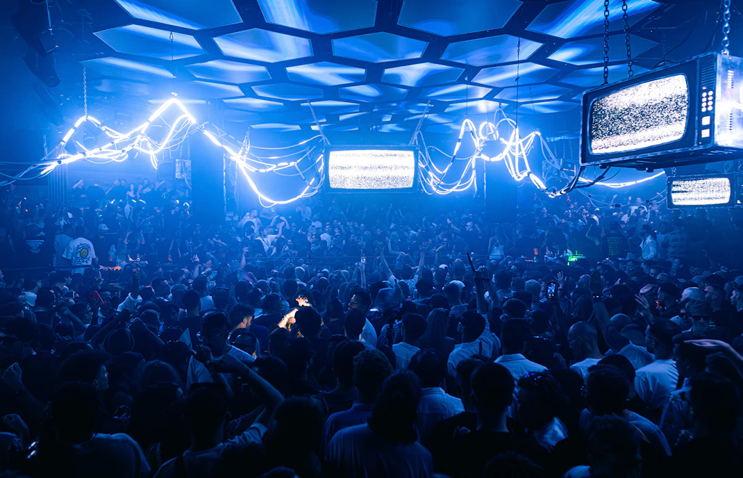 Crowd enjoying a Solomun DJ set in an Ibiza nightclub.