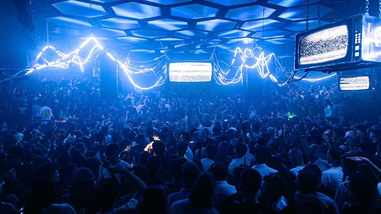 Crowd enjoying a Solomun DJ set in an Ibiza nightclub.