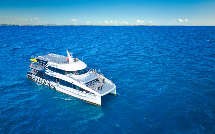 Cruise ship on Auckland's Tikapa Moana, passengers enjoying ocean views.