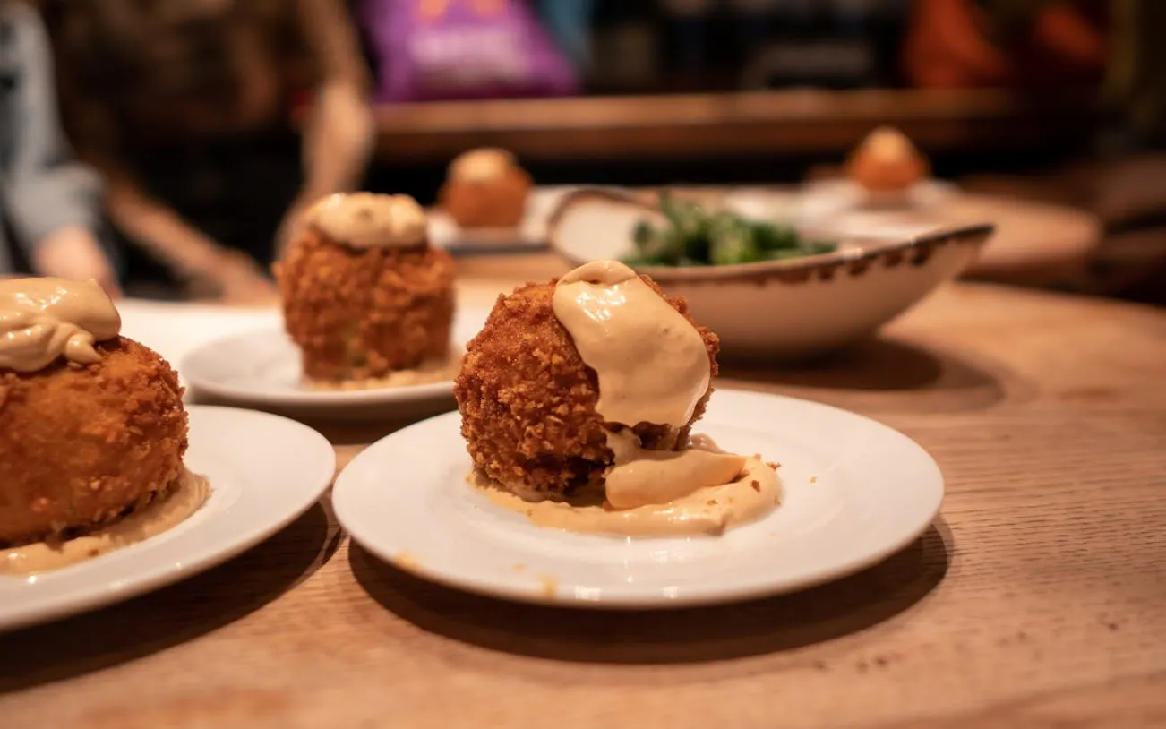 Tapas dish with creamy sauce on a Barcelona wine tour.
