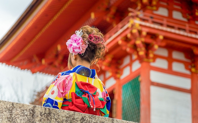 Person in colorful kimono at Kiyomizu Temple, Kyoto.