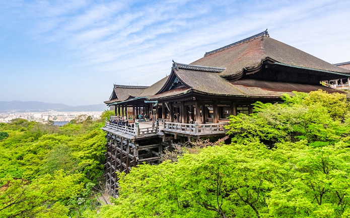 Kiyomizu-dera Temple surrounded by lush greenery on a day tour in Kyoto.