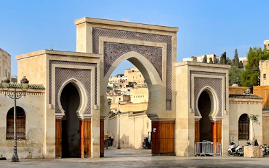 Bab Bou Jeloud gate in Fes Medina, Morocco, with intricate tilework and archways.