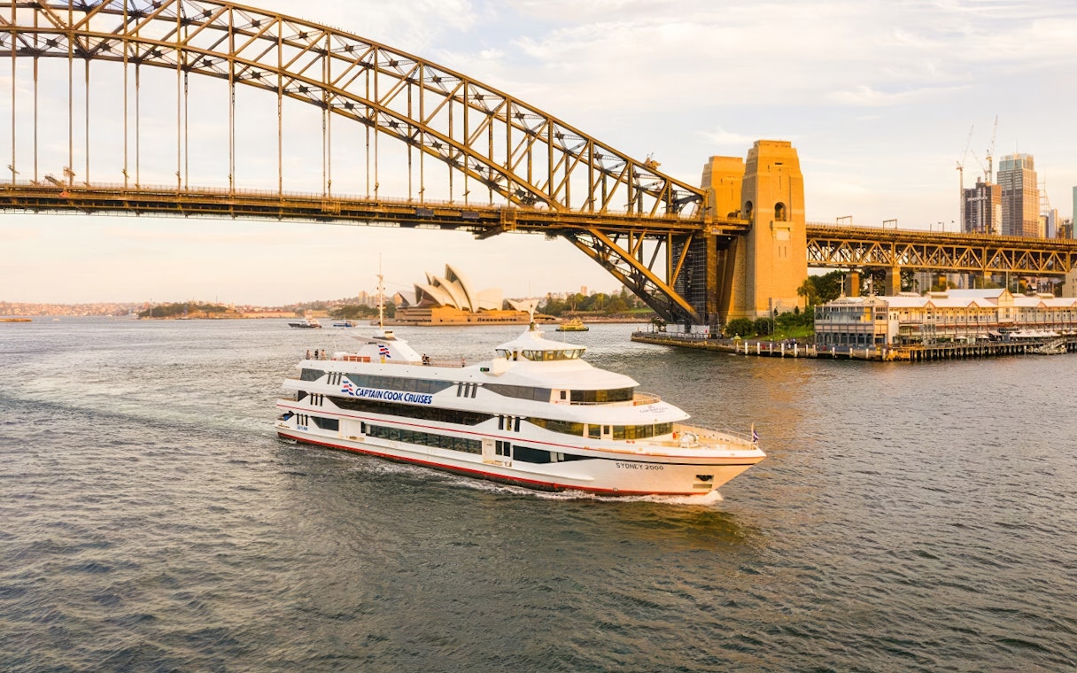 Cruise ship near Sydney Harbour Bridge and Opera House during Starlight Dinner Cruise.