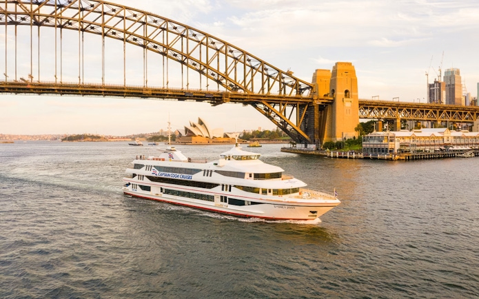Cruise ship near Sydney Harbour Bridge and Opera House during Starlight Dinner Cruise.