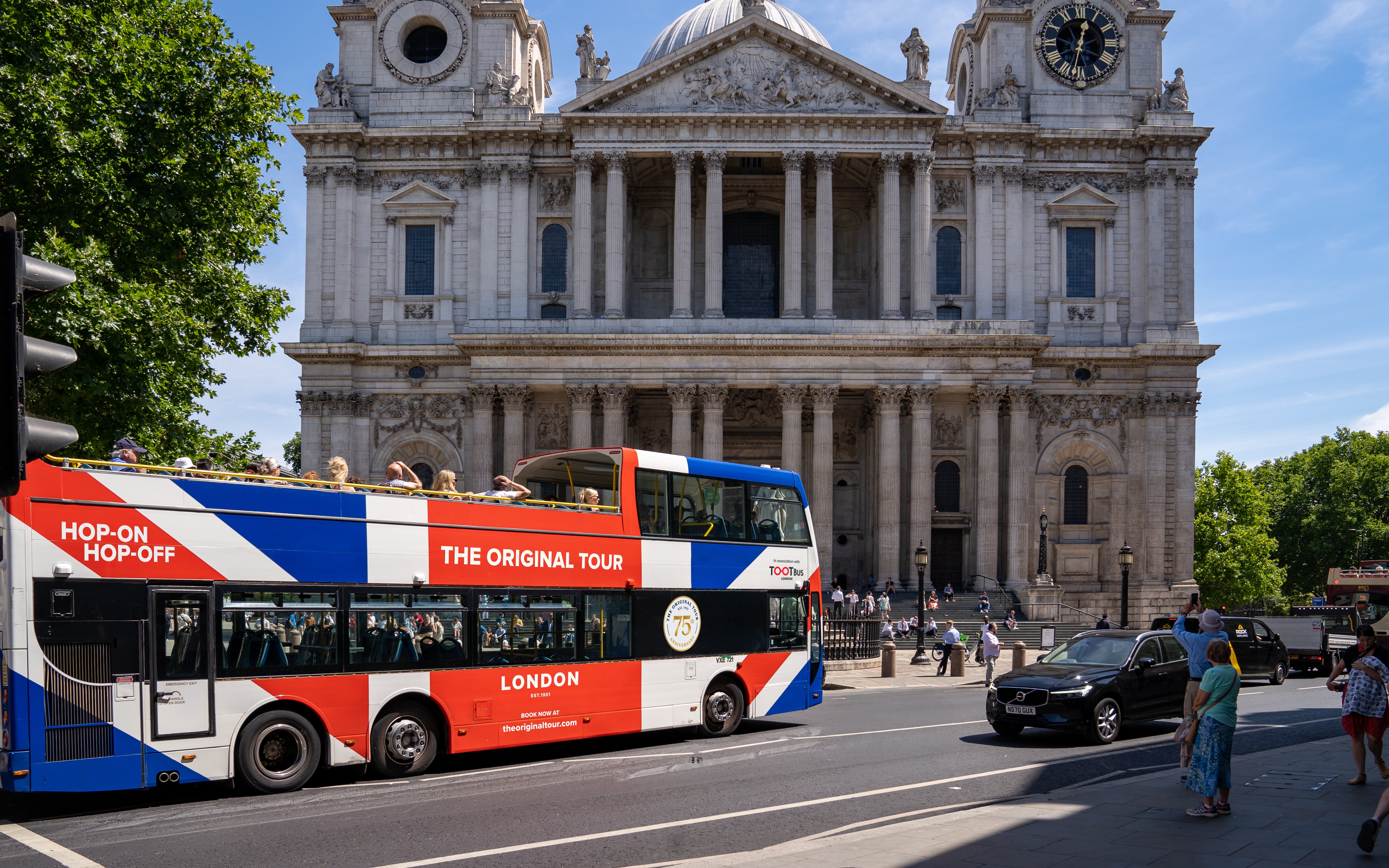Open-top Tootbus passing St. Paul's Cathedral in London.