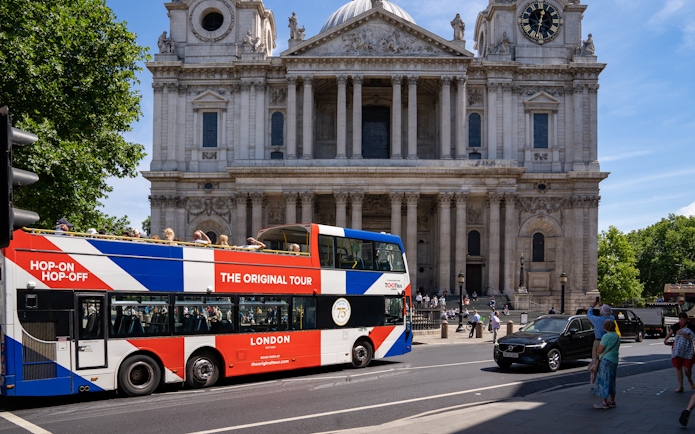 Open-top Tootbus passing St. Paul's Cathedral in London.