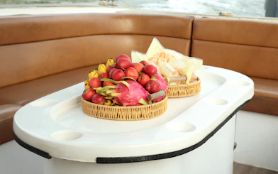 Fruit baskets on a speed boat table during VIP Cu Chi Tunnels tour.