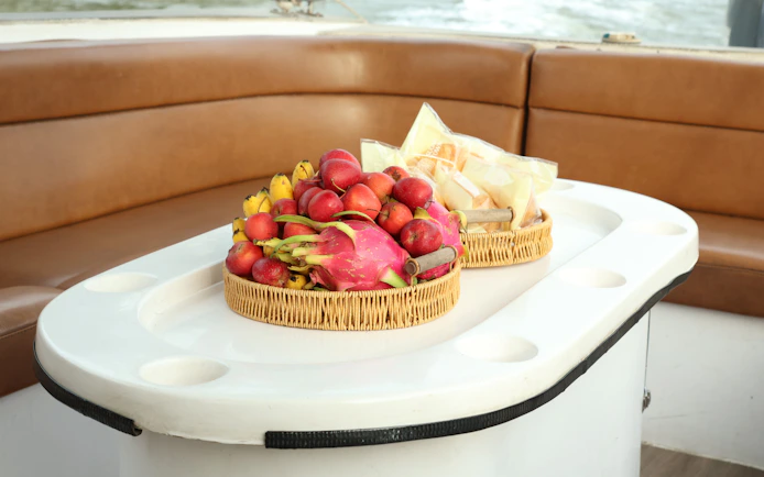 Fruit baskets on a speed boat table during VIP Cu Chi Tunnels tour.