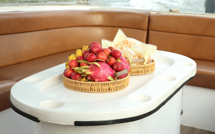 Fruit baskets on a speed boat table during VIP Cu Chi Tunnels tour.