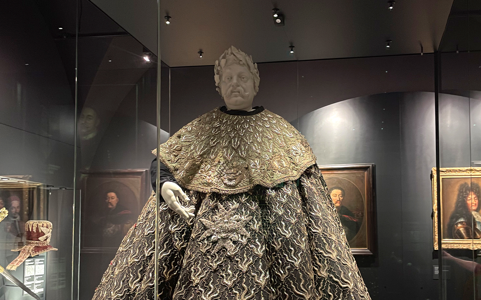 Textile display with ornate robe and mannequin at Wawel Castle.