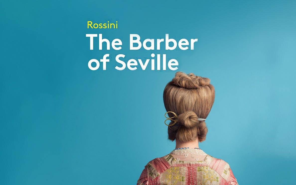 Back view of a person with styled hair and scissors, promoting "The Barber of Seville.