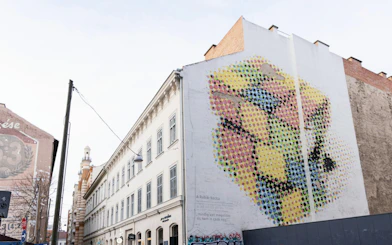 Street art mural on a building in Budapest's Jewish Quarter during guided tour.