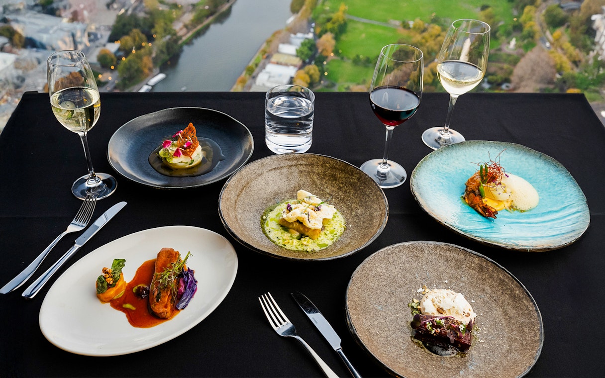 Weekend lunch at Melbourne Skydeck with gourmet dishes and wine overlooking cityscape.
