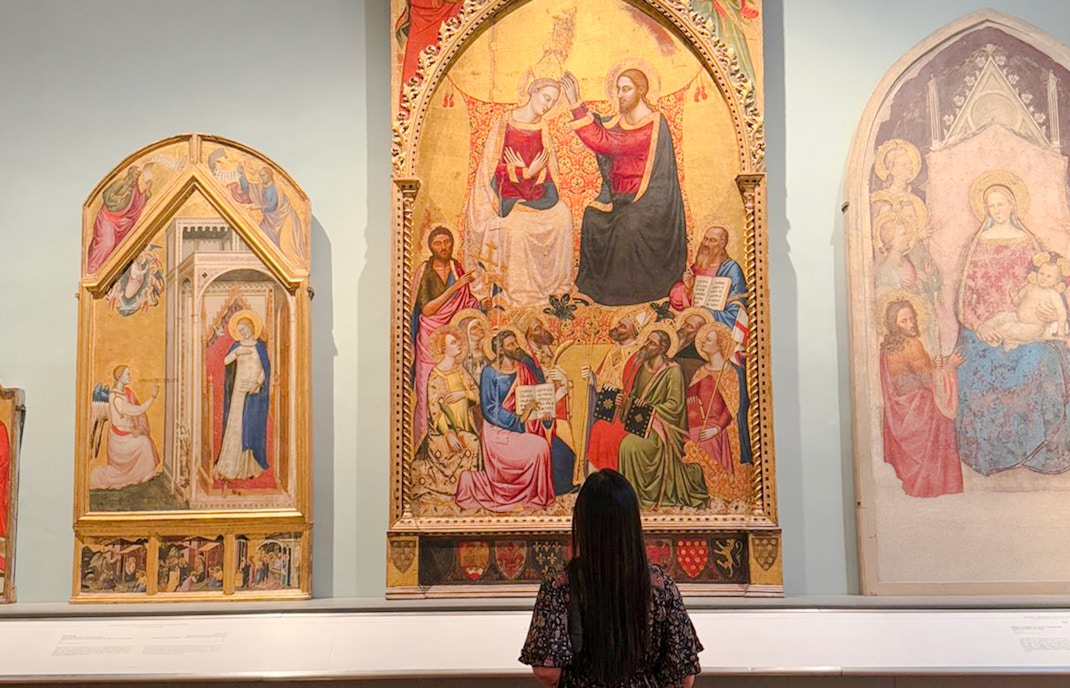 Coronation of the Virgin painting in Accademia Gallery, Florence, viewed by a visitor.