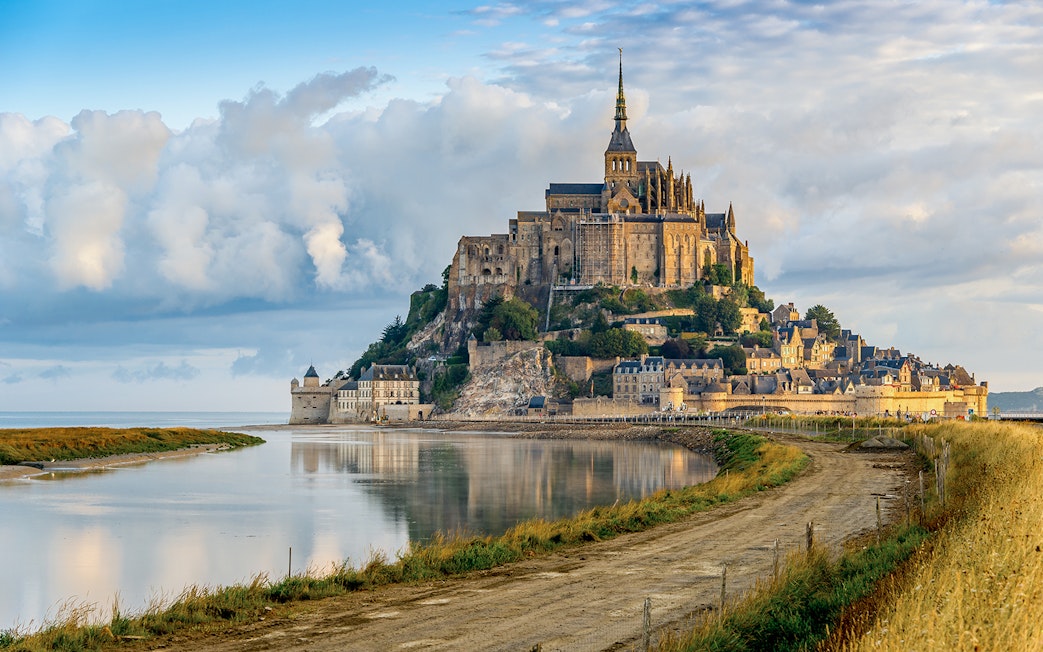 Mont Saint Michel abbey and village on tidal island in Normandy, France.