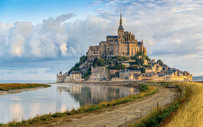 Mont Saint Michel abbey and village on tidal island in Normandy, France.