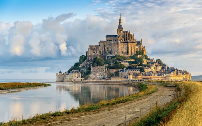 Mont Saint Michel abbey and village on tidal island in Normandy, France.